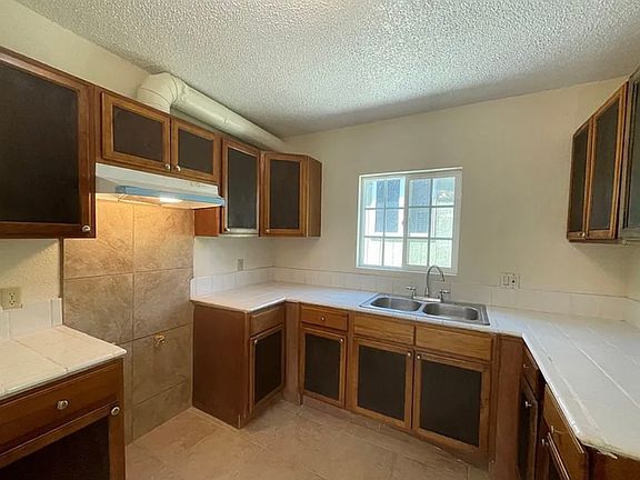 Kitchen includes ample cabinet space & window for fresh air & natural light. Unit now includes brand new gas stove & refrigerator (appliances not pictured here).