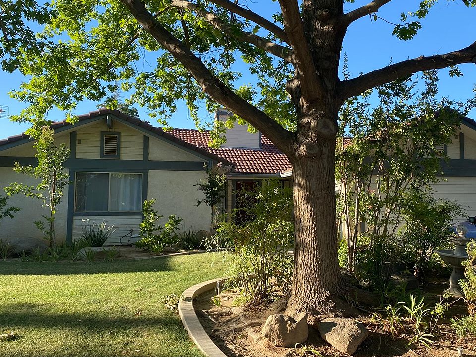 Tile roof, front porch, mature and newer landscaping. Unassuming, yet welcoming.