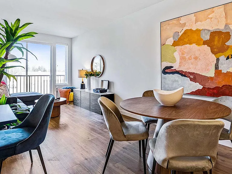 Griffis Shoreline apartment dining area with wood style floor.