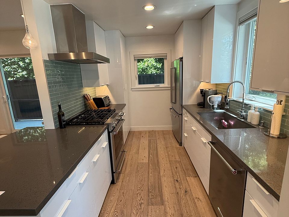 Galley kitchen with island pass through to great room