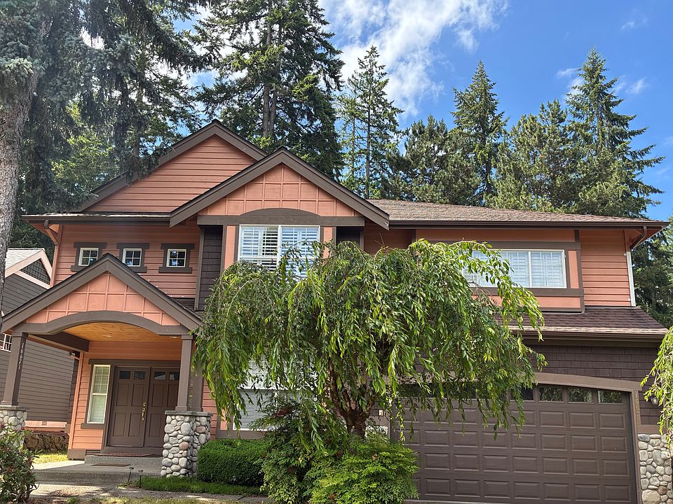 The exterior of this house showcases a mid-century Craftsman style with elegant trim and a refined color palette.