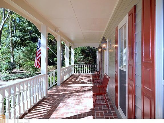 Covered front porch with brick welcomes you, family, and friends
