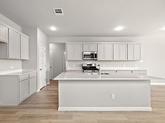 Kitchen in the Elm II home plan by Trophy Signature Homes - REPRESENTATIVE PHOTO
