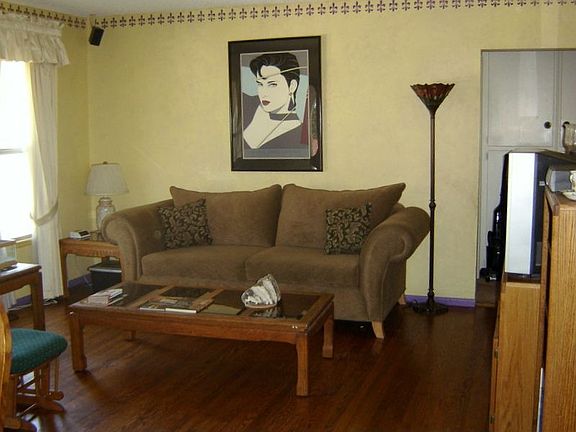 Large and bright window in Living with hardwood floors and surround sound