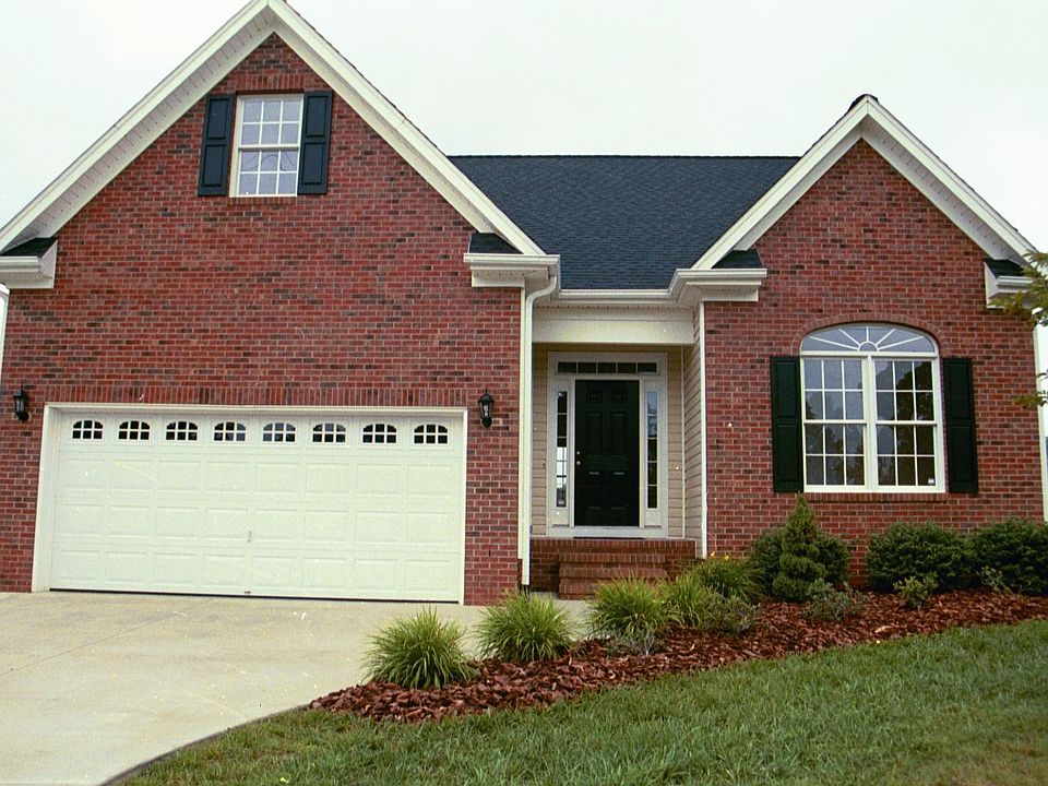 Partial brick home with landscaped yard