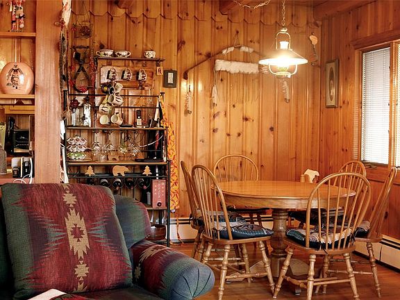 Living room opens into the dining nook and kitchen.