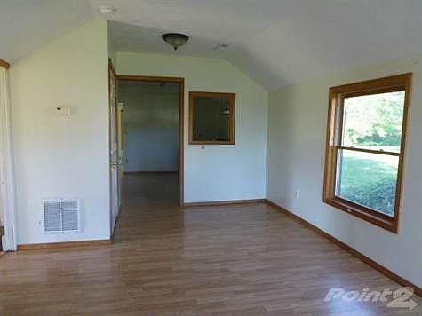 This is the spacious and bright living room with laminate flooring, new trim, windows and fixtures.