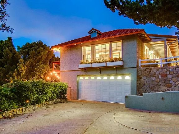 Side of home has plenty of parking beyond the two-car garage