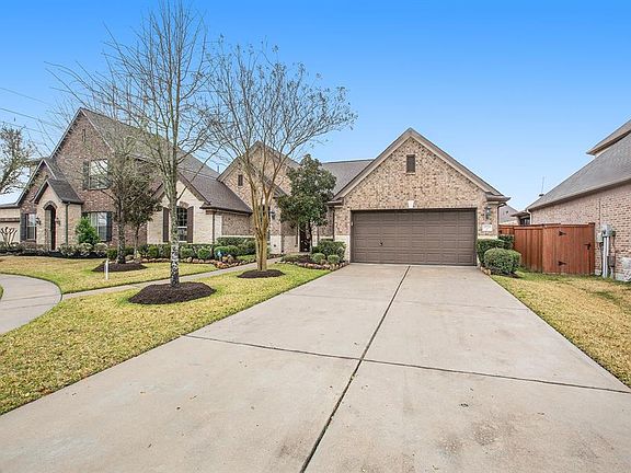 Double wide driveway and 3 car tandem garage provide ample parking space.