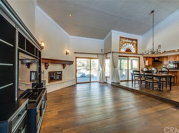 Spacious Family Room with hardwood flooring and glass sliders to backyard