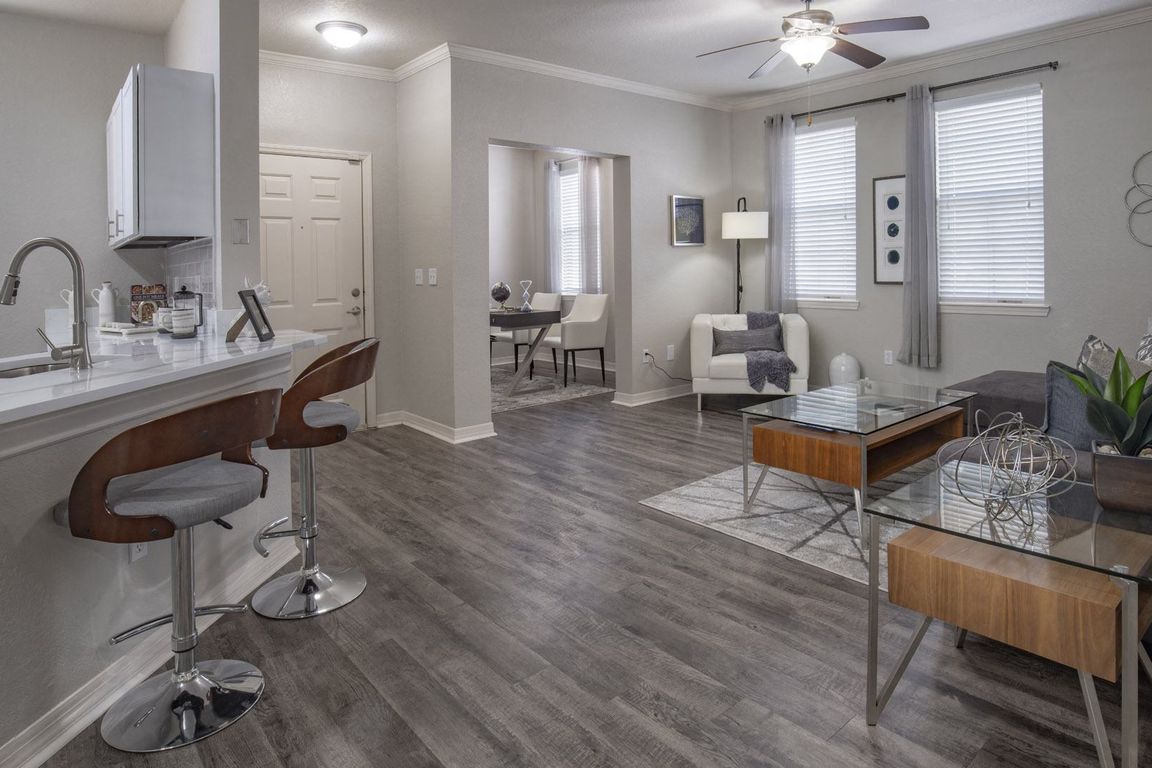 Modern Open Concept Living Room with Breakfast Bar and Wood-Style Flooring