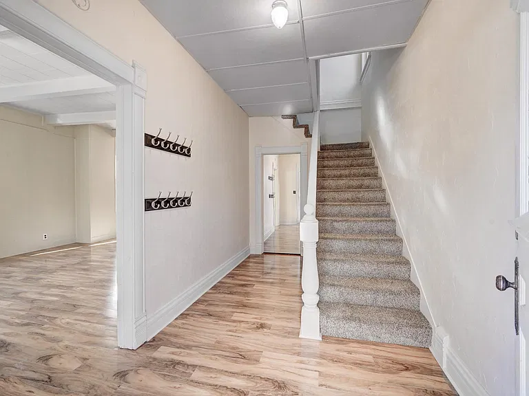 Gracious Entry leads to huge living/dining room or head upstairs to three bedrooms and a full bath