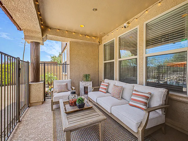 Relax in the covered patio seating area overlooking the pool. For added peace of mind, the pool is enclosed with a secure safety fence, providing an extra layer of protection for children.