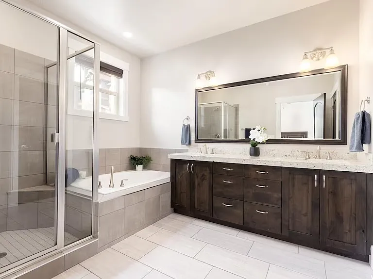 Large en-suite bathroom with double sinks, shower, and tub.
