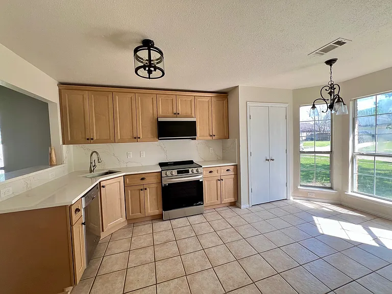 New kitchen cabinets, quartz counters, SS appliances and lighting. Breakfast nook.