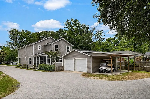 view of back of home with detached garage