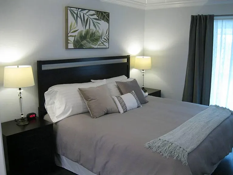 MASTER BEDROOM WITH SLIDING GLASS DOORS OVER LOOKING POOL