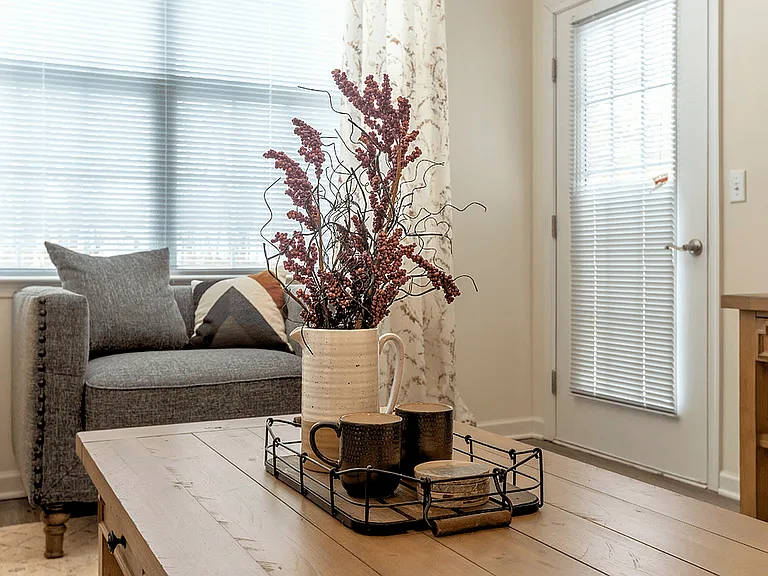 Modern, cozy living spaces with stylish decor, luxury flooring, and warm wood accents for a welcoming feel.