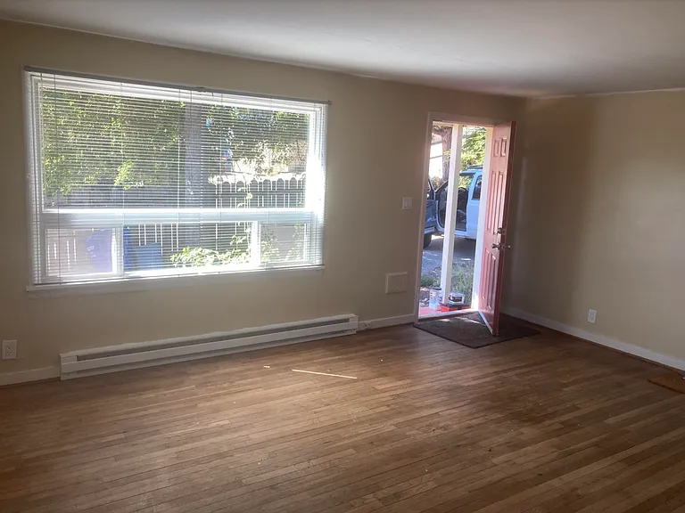 Living room with front door exiting to south