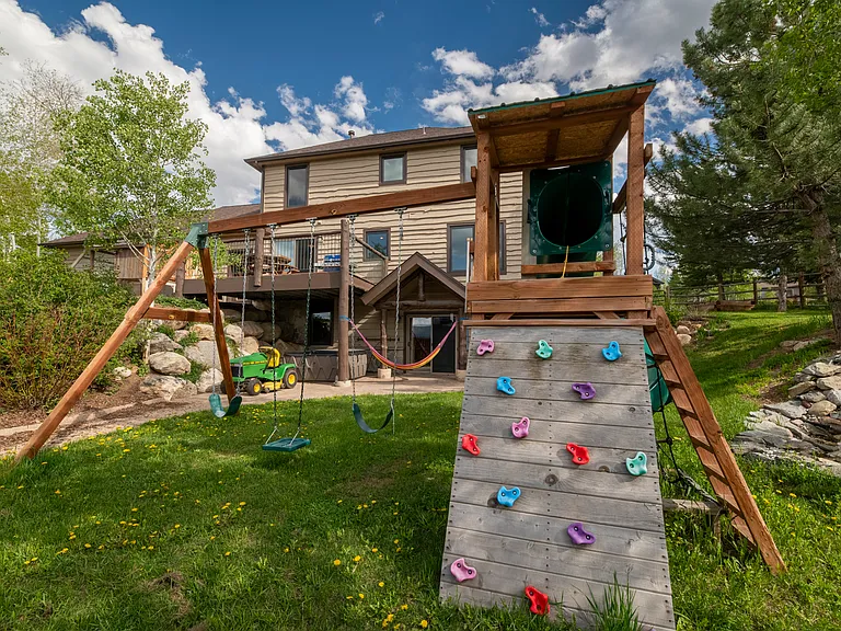 Swing set, climbing wall and slide.