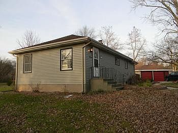 View of the front of the house with garage in background.