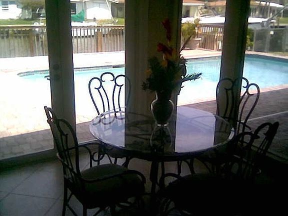 dining area overlooking pool, dock and water way