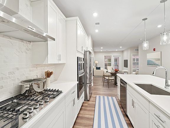 White Cabinetry and Stainless Steel Appliances in the Gourmet Kitchen - Model Representation