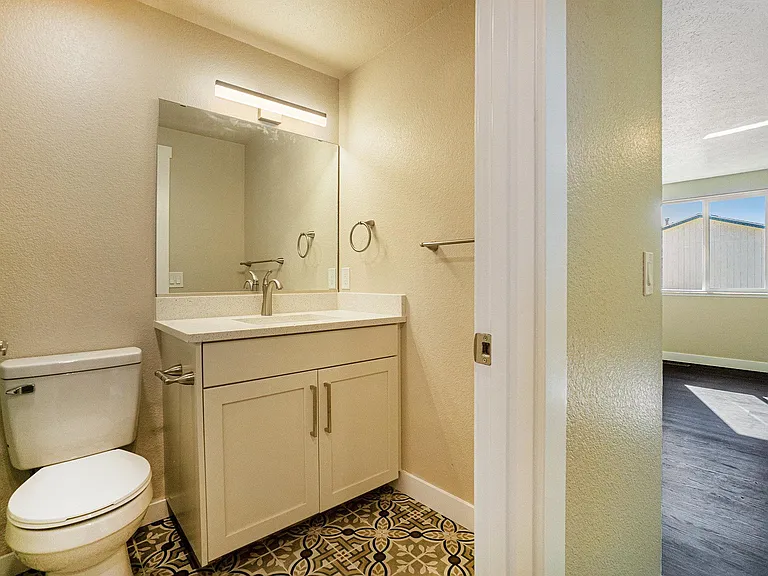 Primary bedroom bath with newer fixtures, flooring, cabinet, hard
surface counter tops and tile surround the tub