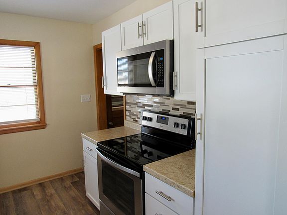 Kitchen/ New Stove and Microwave. New cabinets with broom closet.