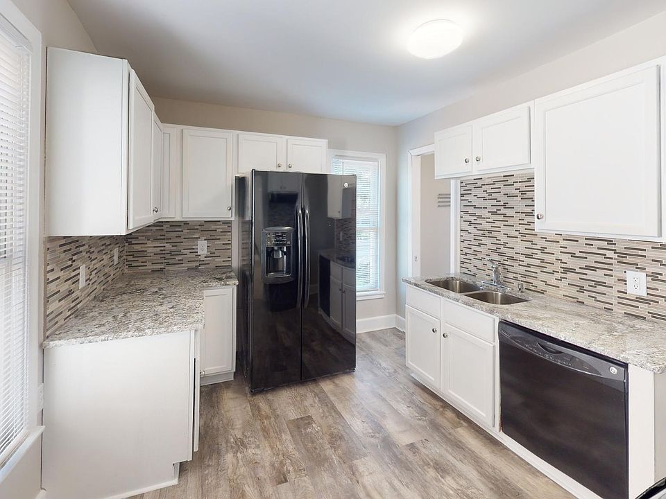 granite counters with tile backsplash, dishwasher