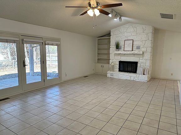 Spacious Living Room with really nice view from 9'-0" wide window which opens up into a back deck overlooking the back yard and Page Belcher Golf Course.