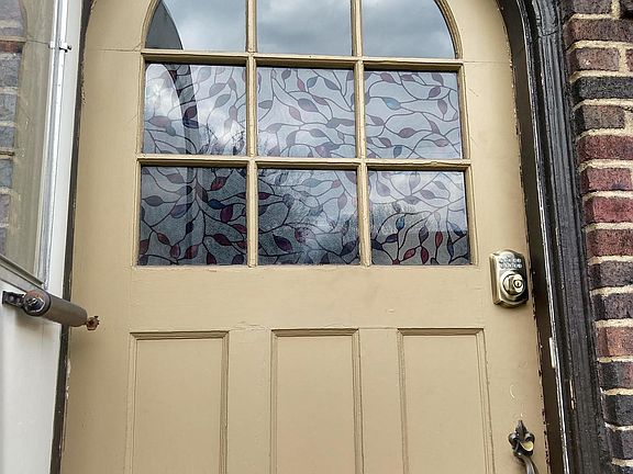 round top front door with inset glass panes