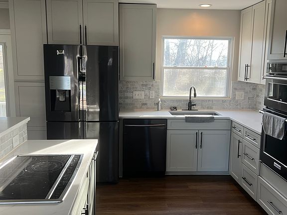 Kitchen with electric stove top, fridge, microwave and oven