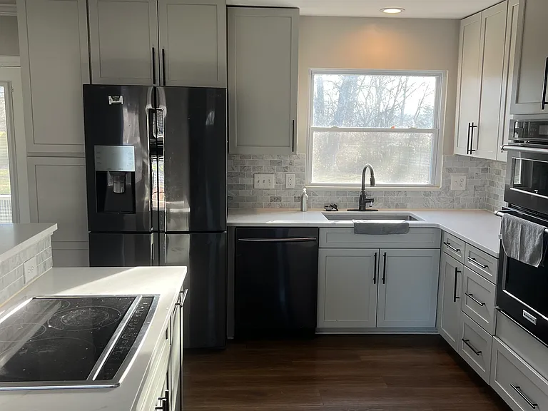 Kitchen with electric stove top, fridge, microwave and oven