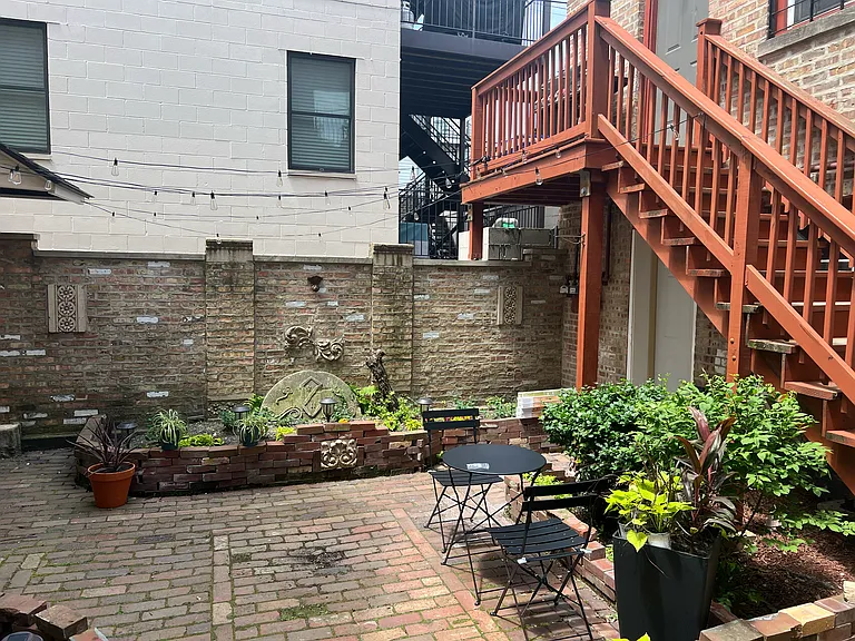 additional daylight courtyard view - bistro table and chairs, canopy lights and new summer flowers and greenery