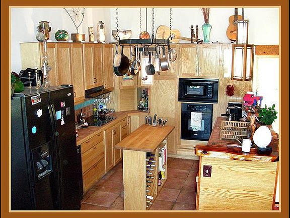 Gourmet Kitchen: L-R Side by side fridge freezer with ice and water, trash compactor, electric range, roll top corner, pantry, microwave, electric oven, toaster oven, air fryer, espresso machine, dishwasher, sink. Totally chef equipped.
