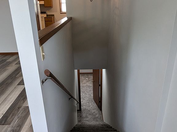 Stairway heading down to the bedrooms and full bath/laundry