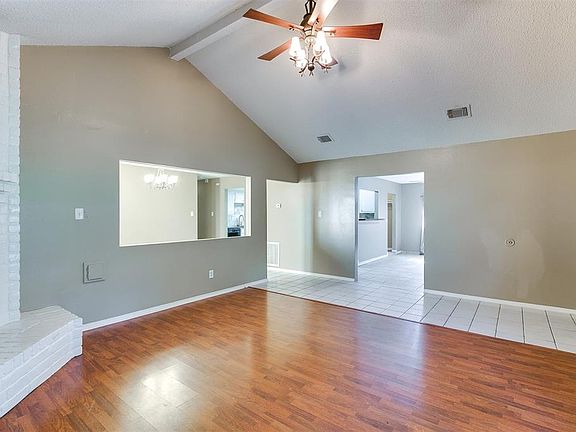 High ceilings, neutral colors, laminate flooring, open floorplan