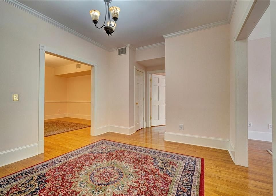 Welcome to 736 Princess Anne! Enormous Foyer opens to living room on right, primary bedroom straight ahead, and dining room, kitchen, and second bedroom and bathroom on the left
