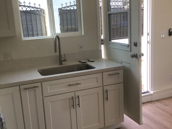 stainless steel sink with arc faucet
kitchen window over looking your private outdoor patio area