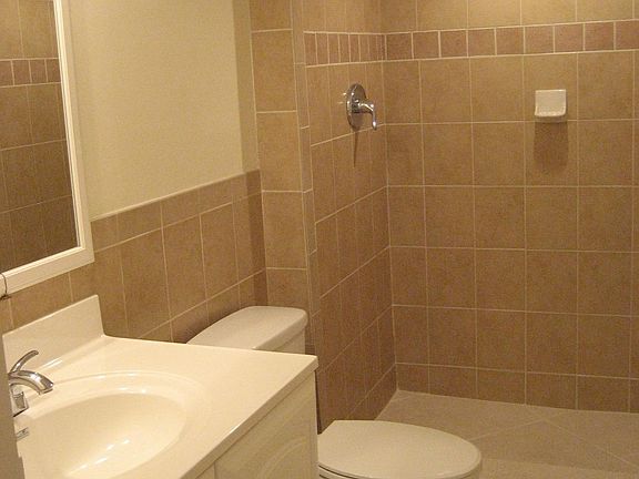 New tiled bathrooms with medicine and vanity cabinets with storage