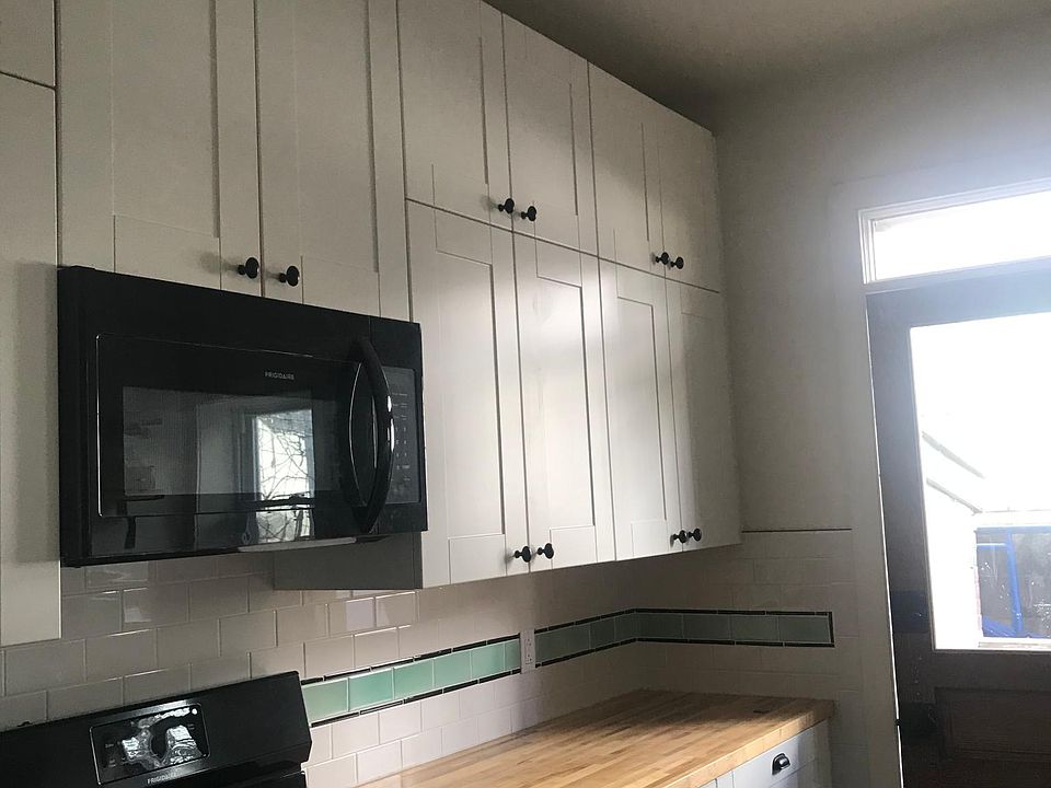 Chef kitchen alert! Notice the double high cabinets, the great butcher block, the gas stove. And yes, there is a dishwasher.