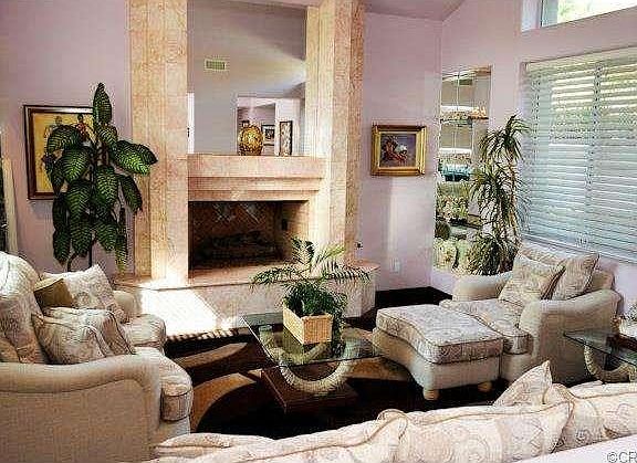 Formal Living Room With Marble Fireplace