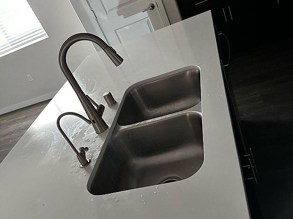 Under sink water filtration system installed. Sensor activated water faucet