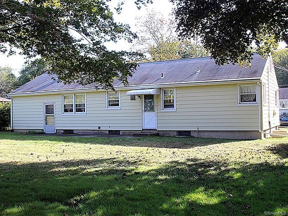 Pretty level back yard, lined with shrubs for privacy.
