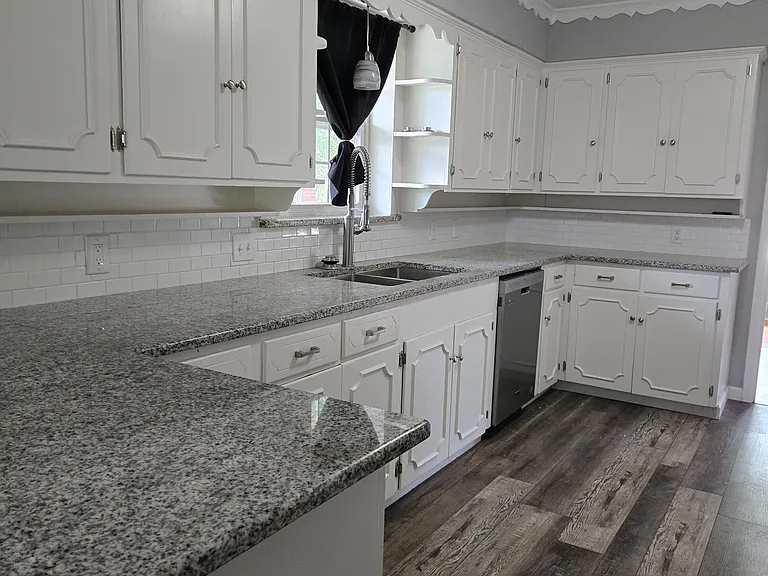 Lots of cabinets & counterspace! On the other side of kitchen is a pantry, above-range microwave, space for a fridge, and laundry area. Acquiring a fridge and a washer and dryer are renter's responsibility (because many renters already have their own).