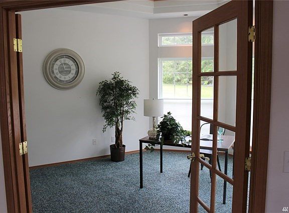 Ample office with big windows let in lots of light and view of neighboring pasture and horses.