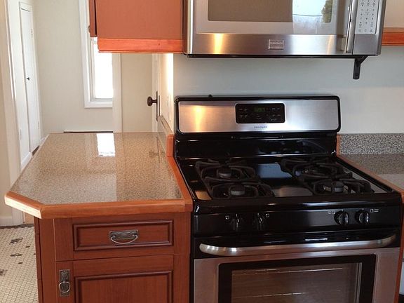 Custom Kitchen with Stainless range and microwave