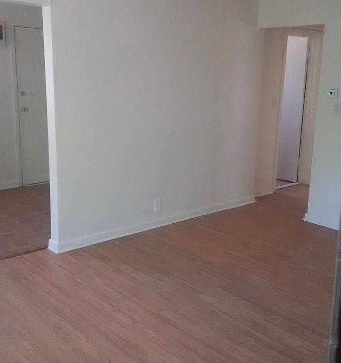 Livingroom with partial kitchen and hallway view