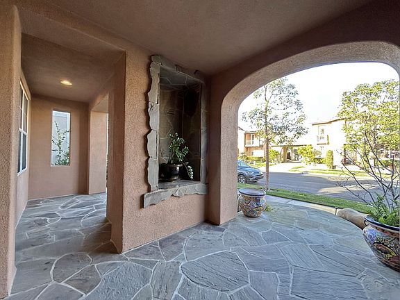 Entrance, patio, and professional landscaping